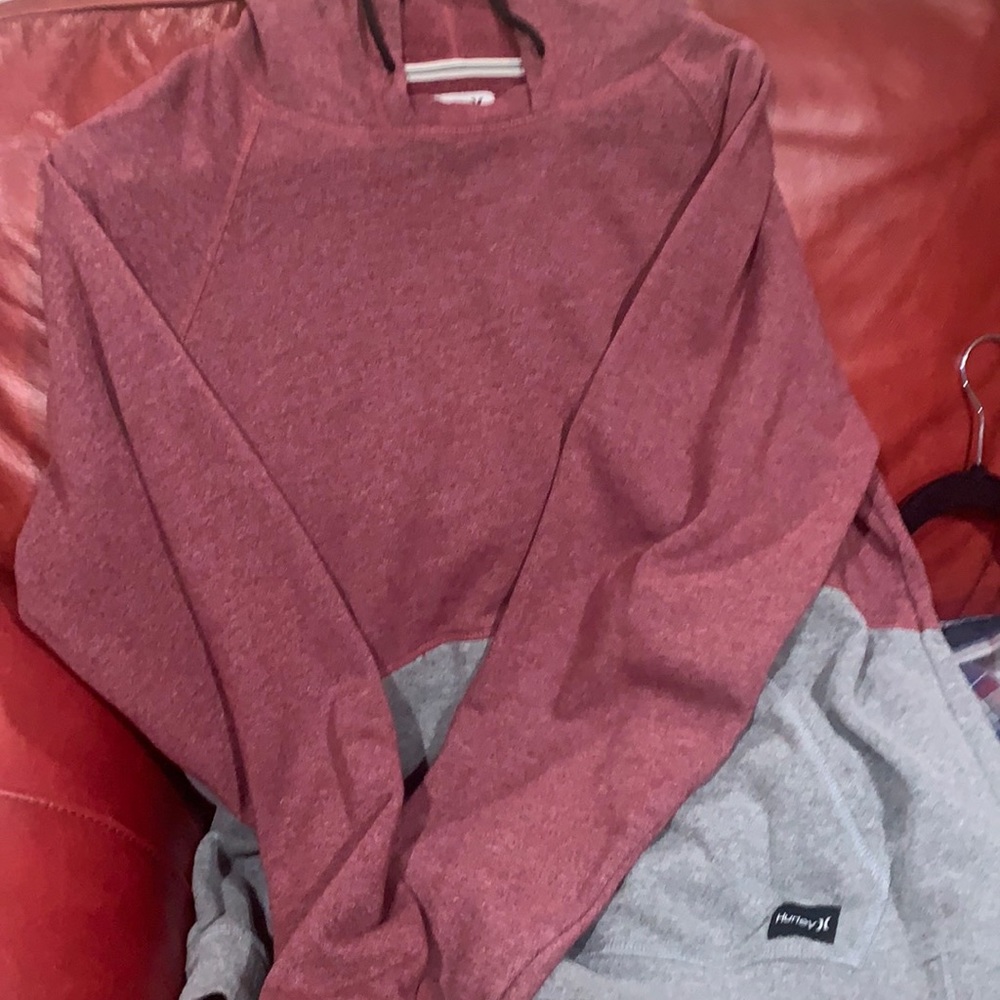 Very nice Hurley sweatshirt, upper half red and lower half gray. Barely worn.